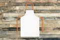 White apron on wooden background Royalty Free Stock Photo