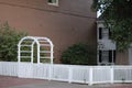 White Arbor with Fence in Front of Historical House Royalty Free Stock Photo