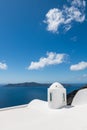 White architecture in Santorini island, Greece. View of the sea and the blue sky with clouds Royalty Free Stock Photo
