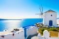 White architecture in Santorini island, Greece. Windmill in Oia town at sunny day Royalty Free Stock Photo