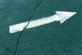 White arrow on cyan toned asphalt surface. Royalty Free Stock Photo