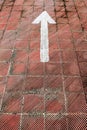 White arrow painted on a parking floor