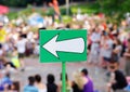 White arrow sign against crowd