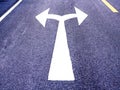 White arrow sign on asphalt road, Turn left and right signs on the road junction Royalty Free Stock Photo