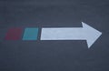 White arrow sign on black floor Royalty Free Stock Photo