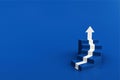 White arrow up with blue stair on blue floor background, 3D arrow climbing up over a staircase , 3d stairs with arrow going upward Royalty Free Stock Photo