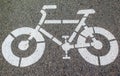 White arrows and bicycle sign path