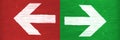 White arrows pointing directions right and left manually painted on green and red wooden signboard background