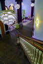 White Artichoke Lamps Illuminating a Foyer Staircase.