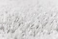 White artificial grass texture with blurred background. Modern monochrome backdrop. Exterior interior material