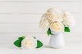 White artificial roses in vase