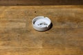 White ash tray on wooden table. Royalty Free Stock Photo