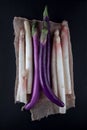 White aspargus and purple violet aubergines decorated with napkin on a kitchen table