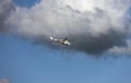 White attack helicopter of the United Nations peacekeeping mission in flight against the background of dark cloud Royalty Free Stock Photo