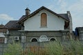 White attic of a private rural house behind a gray concrete fence Royalty Free Stock Photo