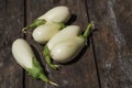 White aubergines on an old wooden textural background. Royalty Free Stock Photo