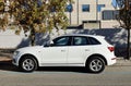 White Audi Q5 hybrid n a city street.