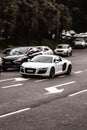 White Audi R8 on a dark street with blurred background