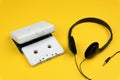 A white audio cassette tape and a white portable cassette player