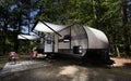 White awnings out on an RV in a campsite