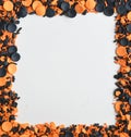 Orange and Black Candy Sprinkles Border on White Background Royalty Free Stock Photo