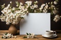 White backdrop embellished with a cup of coffee, notepad, and flowers