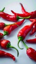 White background adorned with a close up of fiery red peppers