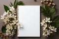 White background adorned with coffee, notepad, and fresh flowers