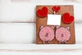 On a white background brown handmade Board with the image of hearts and pigs .layout for greeting card