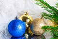 On a white background Christmas balls blue and gold and green fir branches. Christmas concept Royalty Free Stock Photo