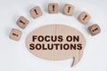 On a white background, cubes with an exclamation mark and a sign - thoughts with the inscription - FOCUS ON SOLUTIONS