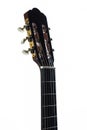 White background detail of the neck and pegs of a Spanish guitar. Brown classical guitar with detail of guitar strings Royalty Free Stock Photo