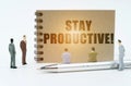On a white background, figures of businessmen, a pen and a notepad with the inscription - Stay Productive Royalty Free Stock Photo