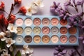 White background, flat lay of eyeshadow palette and flowers, text space
