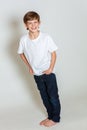 Young happy boy smiling hands in pockets wearing blue denim jeans Royalty Free Stock Photo