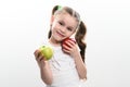 On a white background, the girl holds two green and red apples in her hands Royalty Free Stock Photo