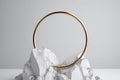 white background with golden ring, round frame integrated into chalk rock stone, aesthetic minimalist Generative AI. Royalty Free Stock Photo