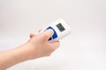 On a white background, a hand holds an electronic thermometer with a reading of 37.9 Royalty Free Stock Photo
