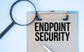 On a white background magnifier, a pen and a sheet of paper with the text endpoint security . Business Royalty Free Stock Photo
