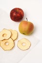 Frips. Slices. Dried apples on parchment paper. On a white background, place for text.