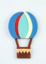 On a white background, a plasticine balloon with a basket, children`s applique.