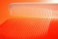 White background with red comb and backlight Royalty Free Stock Photo
