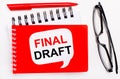 On a white background, white and red notepads, black glasses, a red pen and a white card with the text FINAL DRAFT Royalty Free Stock Photo