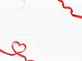 white background with a red ribbon folded in the shape of a heart. Copyspace. Valentine's Day card Royalty Free Stock Photo