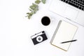 White background with retro camera, laptop, notebook and coffee, top view. Royalty Free Stock Photo