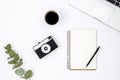 White background with retro camera, laptop, notebook and coffee, top view. Royalty Free Stock Photo