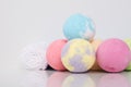 On a white background, a set of balls of multicolored sea salt with a towel, for taking a bath Royalty Free Stock Photo