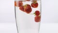 Juicy and fresh strawberries in water.Close-up.On a white background