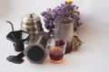 White background, strong, morning, specialty coffee brewed by an alternative method from gadget. Bouquet of field flowers and glas