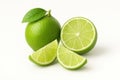 On a white background there is a whole lime with a green leaf, a lime cut in half and two slices. The bright composition Royalty Free Stock Photo